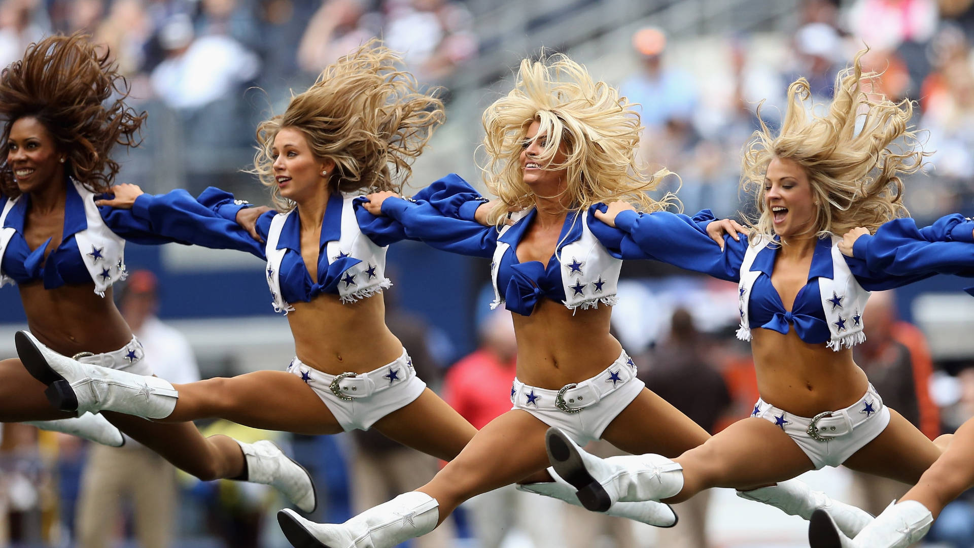 Jumping Cheerleaders For The Awesome Dallas Cowboys Background