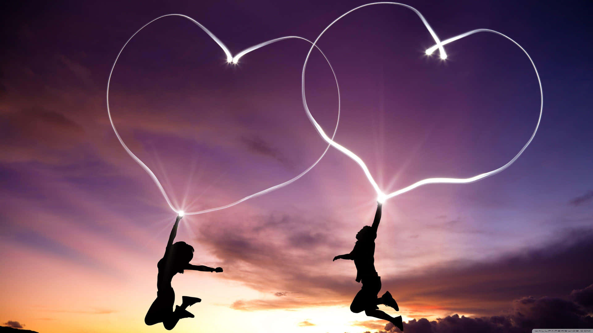 Jumping Couple With Corresponding Light Hearts