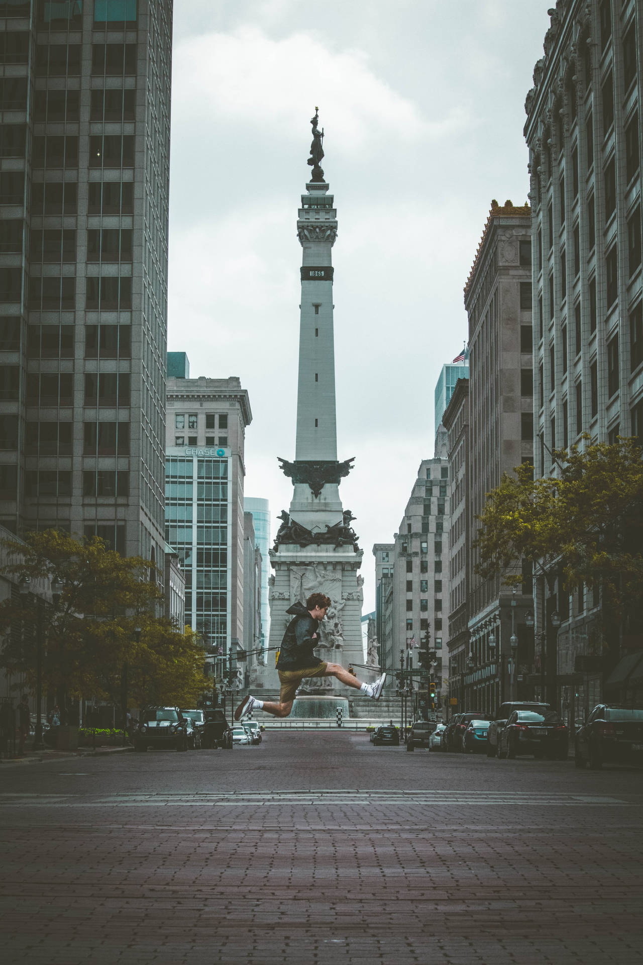 Jumping Front Of Indianapolis Monument Background