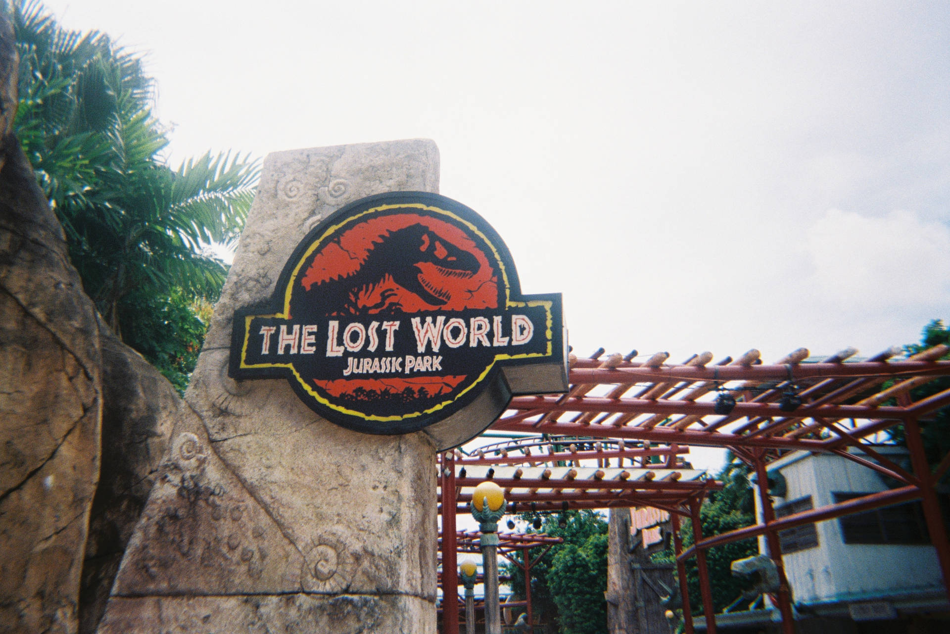 Jurassic World Logo In Town Background