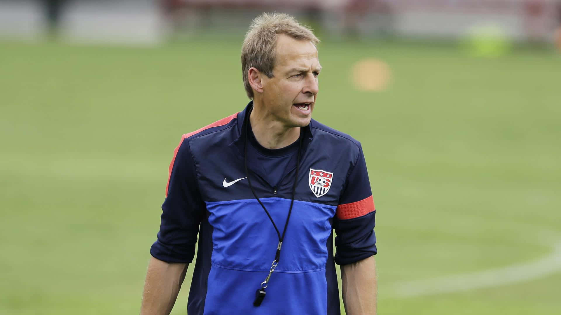 Jurgen Klinsmann On Football Field Background