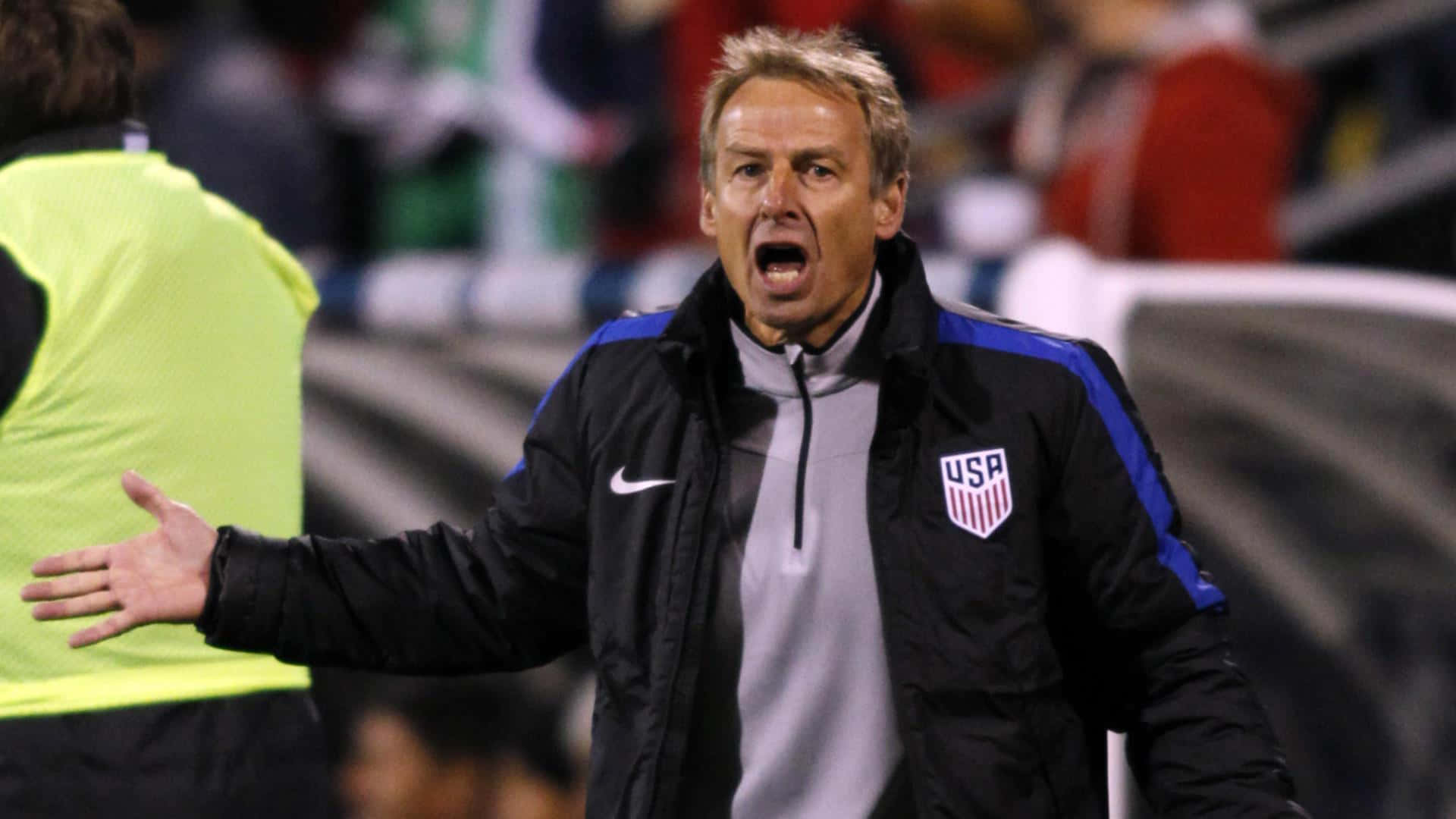Jurgen Klinsmann Shouting And Extending Arms Background