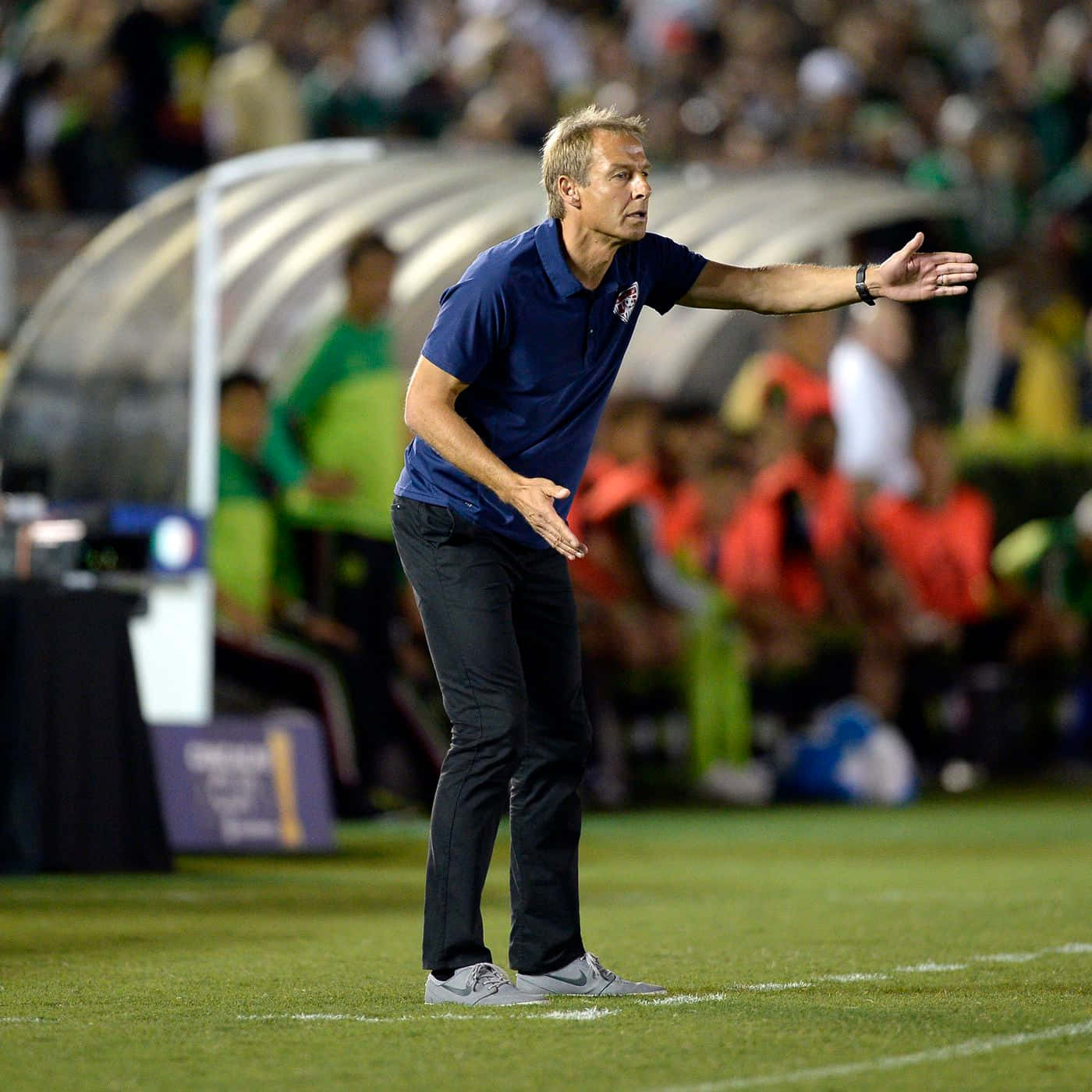 Jurgen Klinsmann Standing Doing Signals Background