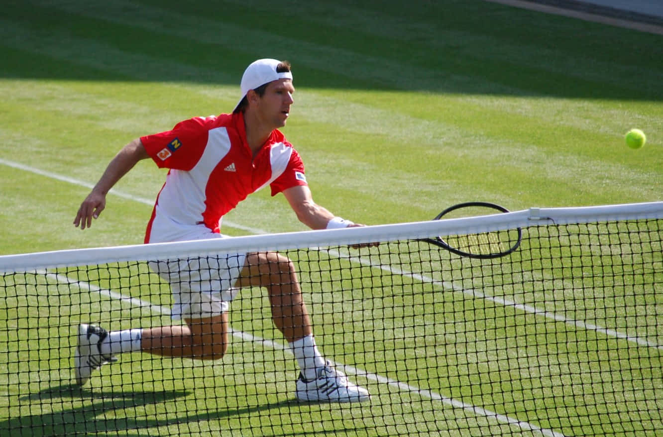 Jurgen Melzer In Action Donned In Red And White Tennis Attire