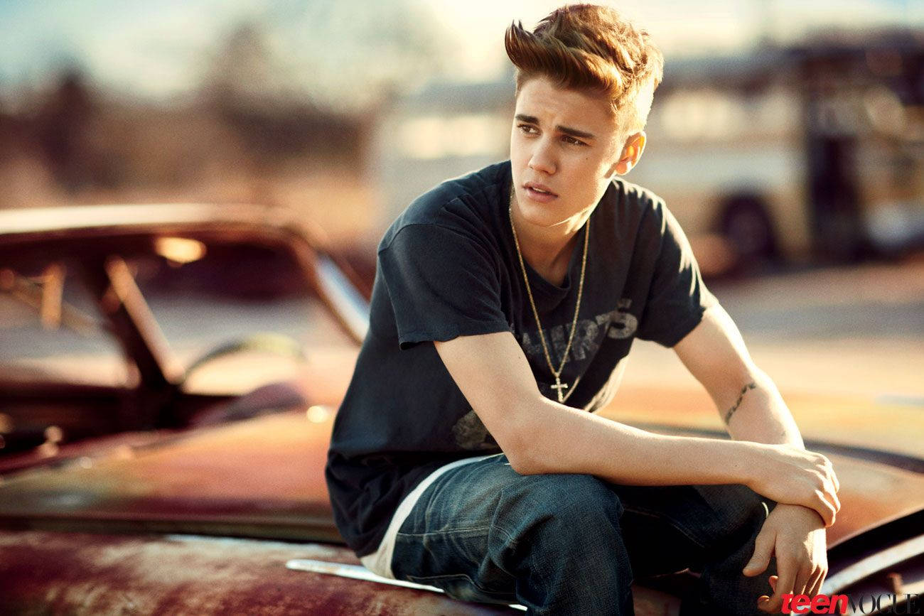 Justin Bieber Poses With A Vintage Car.