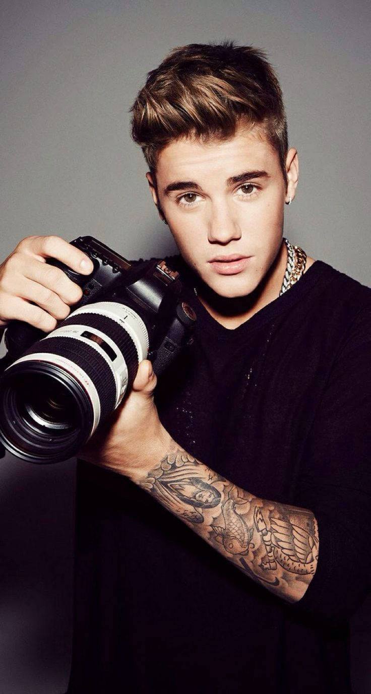 Justin Bieber Smiles Brightly In A Close-up Portrait Background