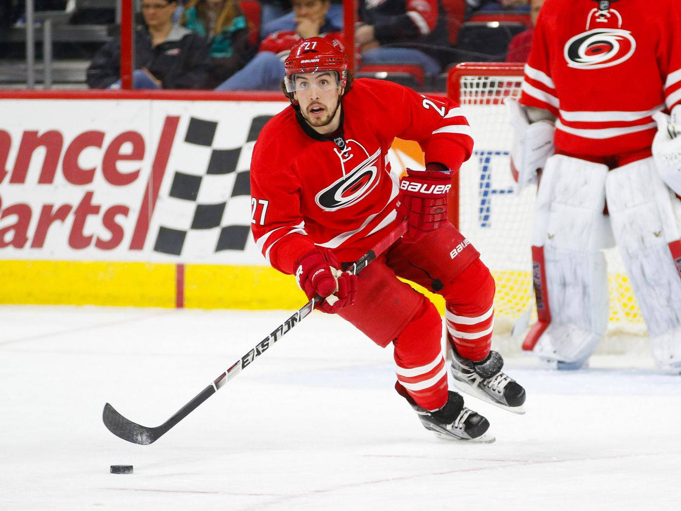 Justin Faulk In Action In Red Uniform Background