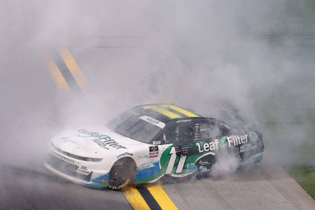 Justin Haley Car Covered In Smoke Background