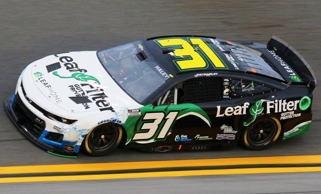 Justin Haley Triumphantly Atop His Race Car Background