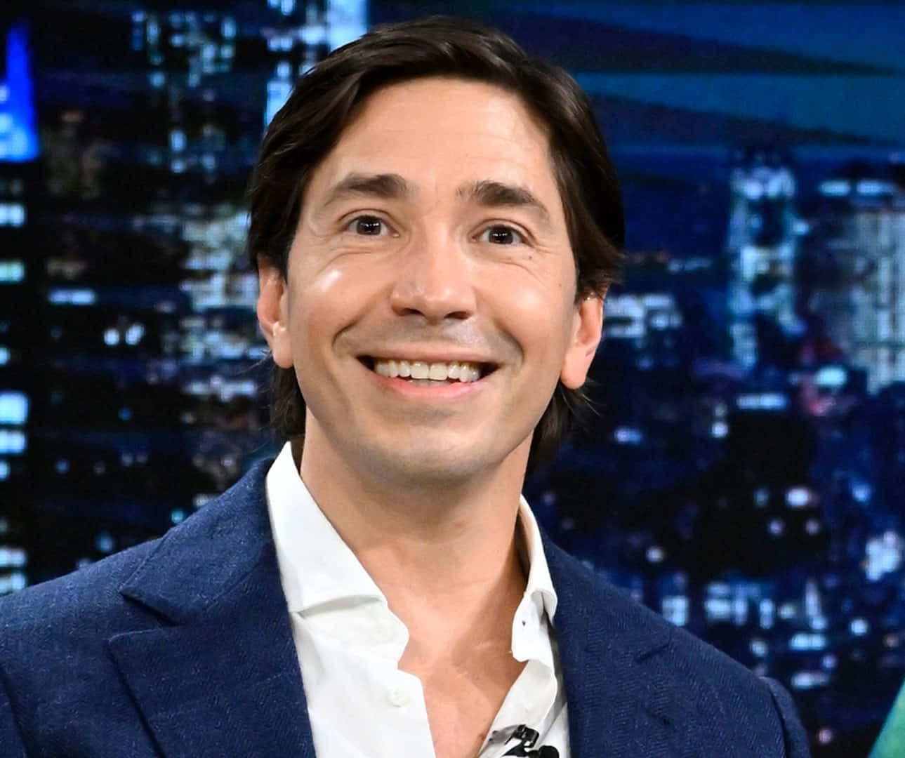 Justin Long Smiling In A Blue Shirt
