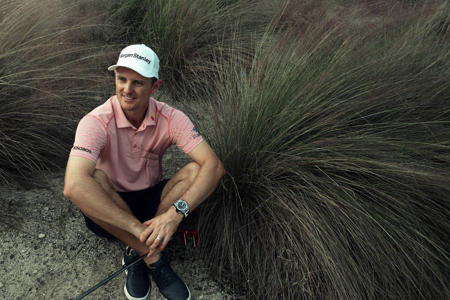 Justin Rose Sitting Beside A Bush