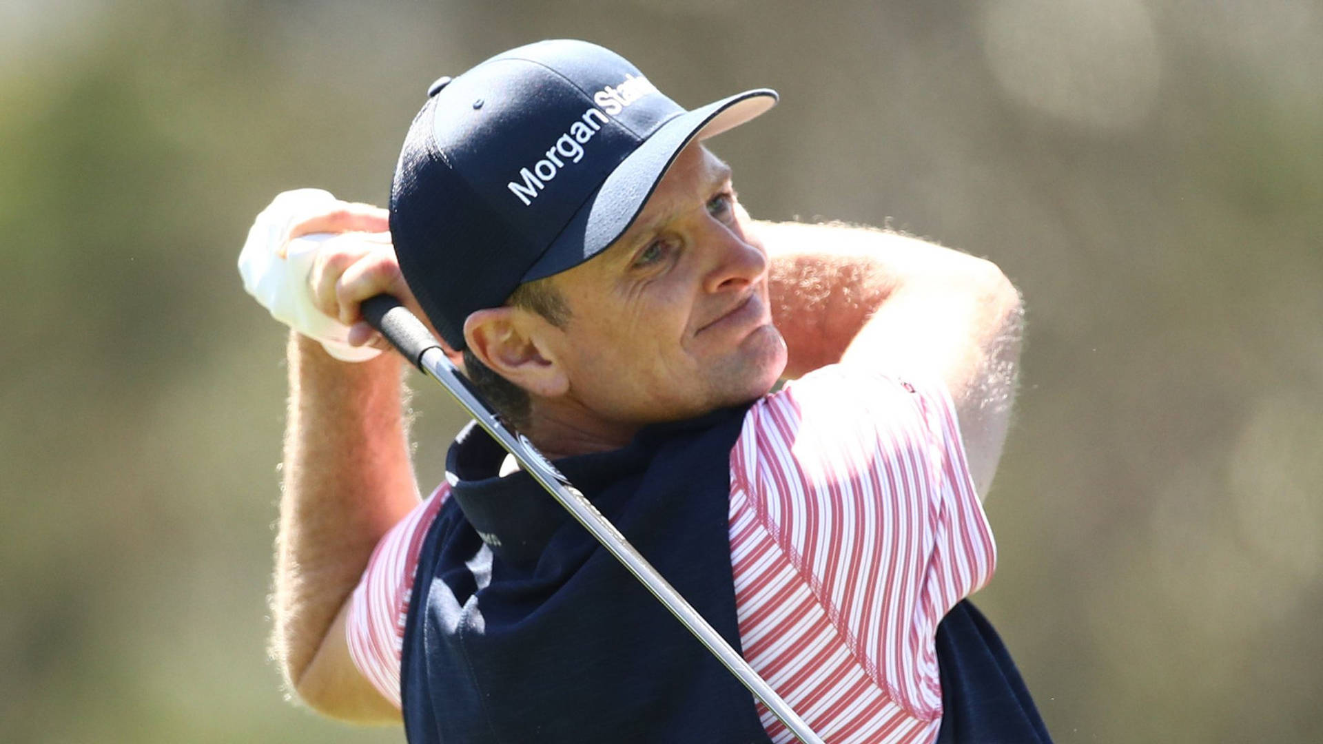 Justin Rose Wearing A Pink Striped Shirt Background