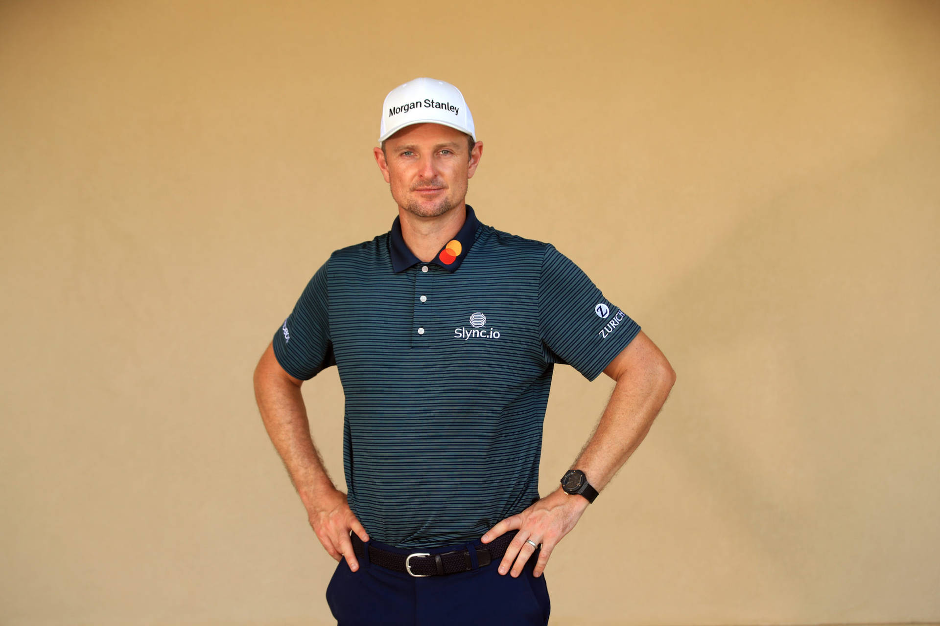 Justin Rose With Hands On His Waist Background