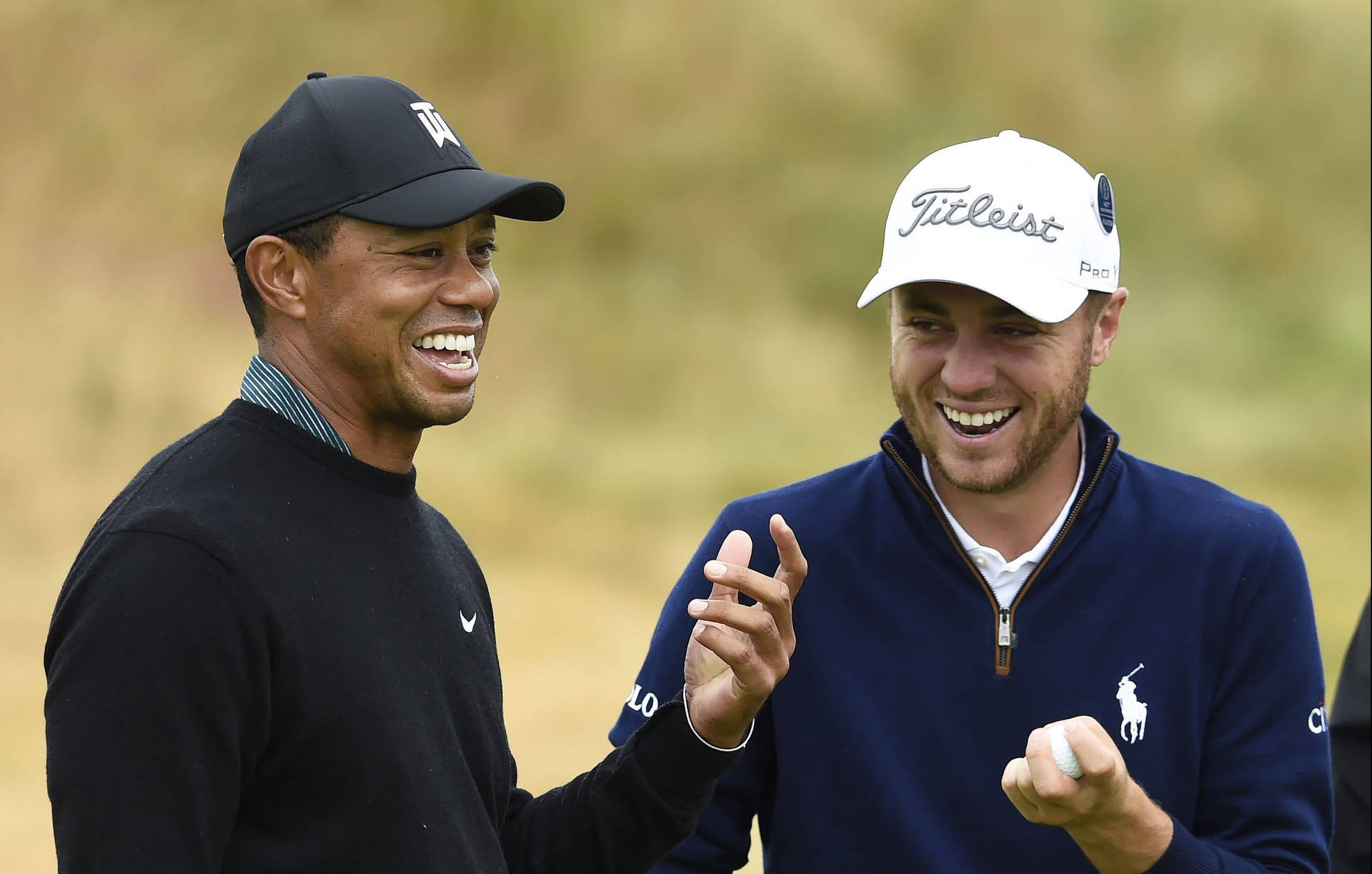 Justin Thomas Laughing With Tiger Woods Background