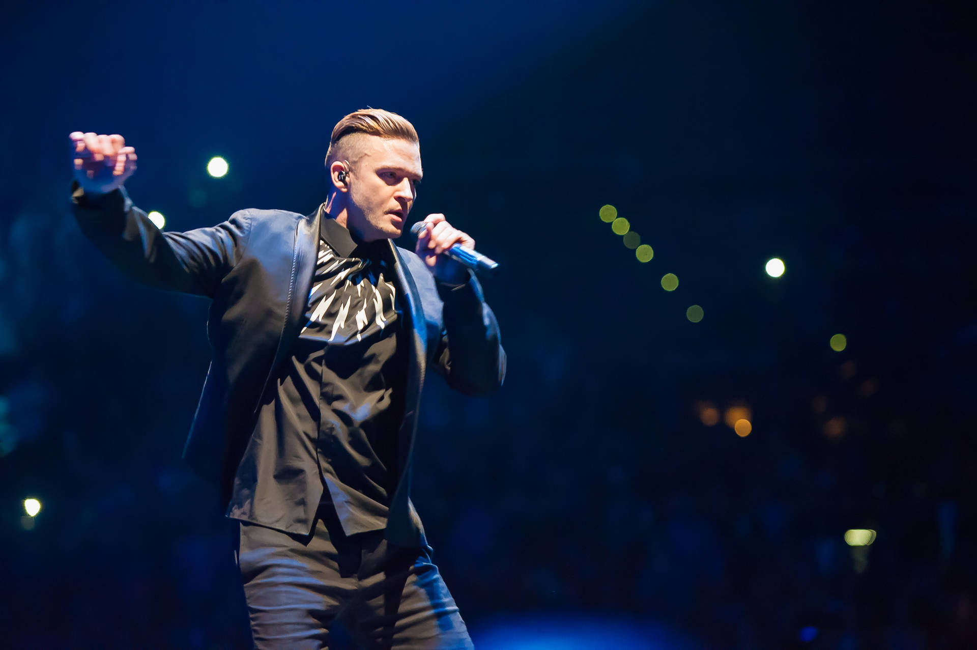 Justin Timberlake Singing In Dark Arena Background