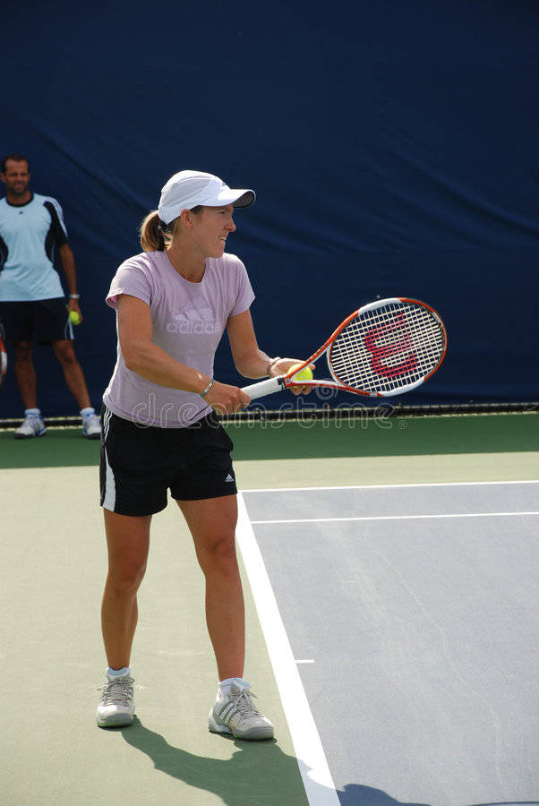 Justine Henin Showing Remarkable Skills On Tennis Court Background