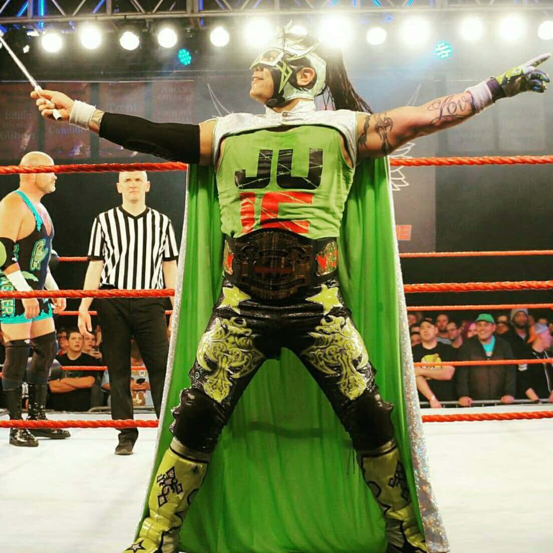 Juventud Guerrera In Green Wearing Wcw Belt Background