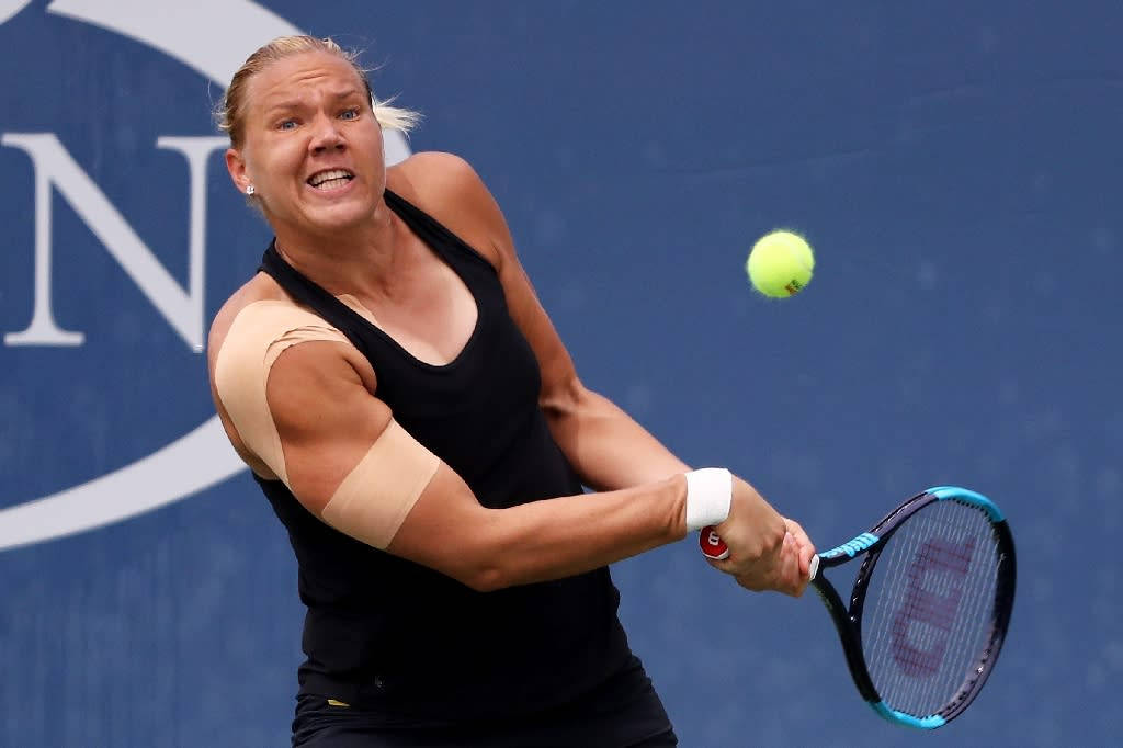 Kaia Kanepi In Action During A Tennis Match Background