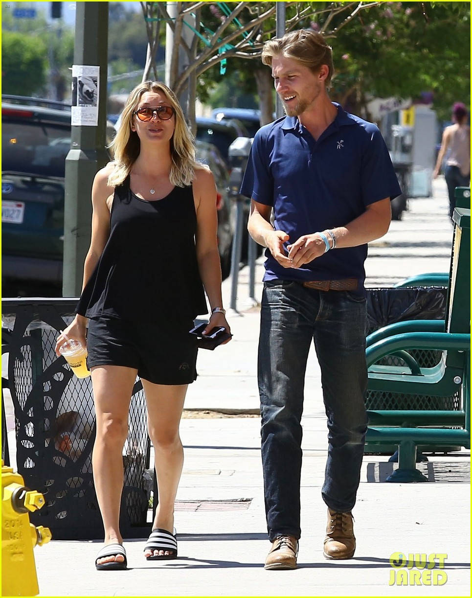 Kaley Cuoco And Karl In Street Background