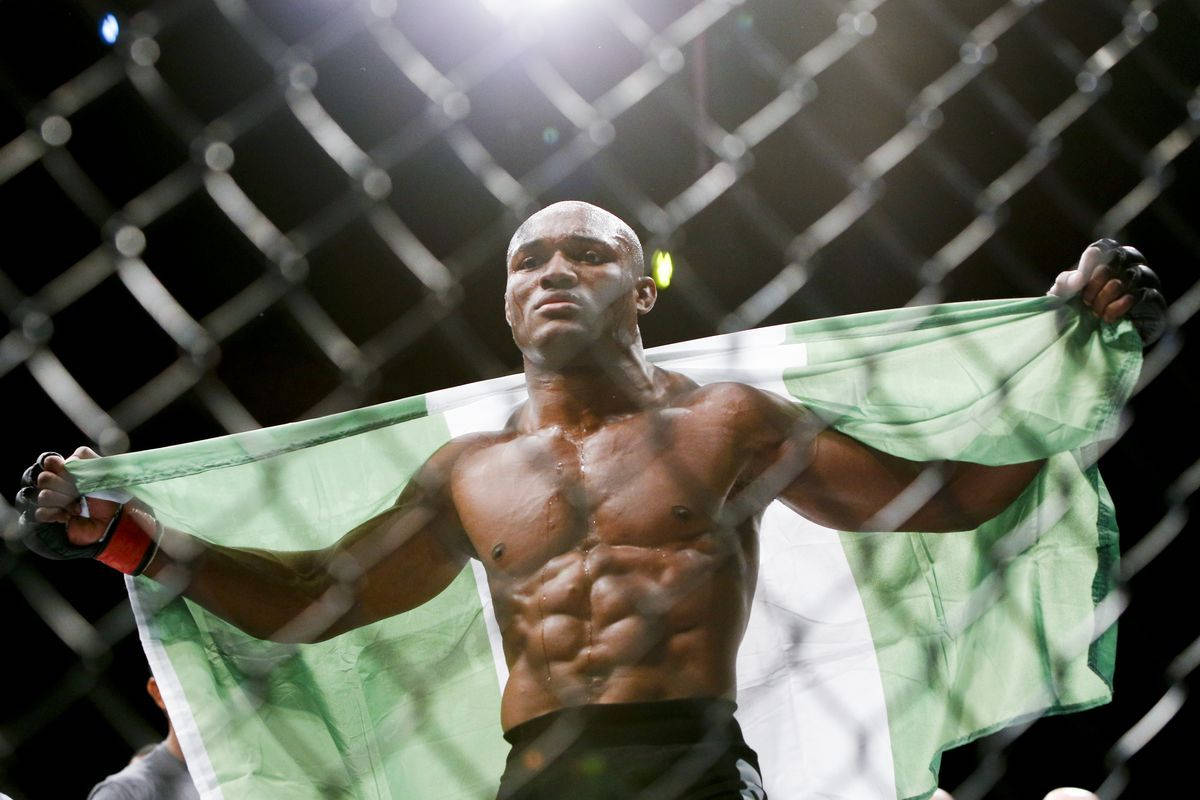 Kamaru Usman Holds Flag Octagon Background