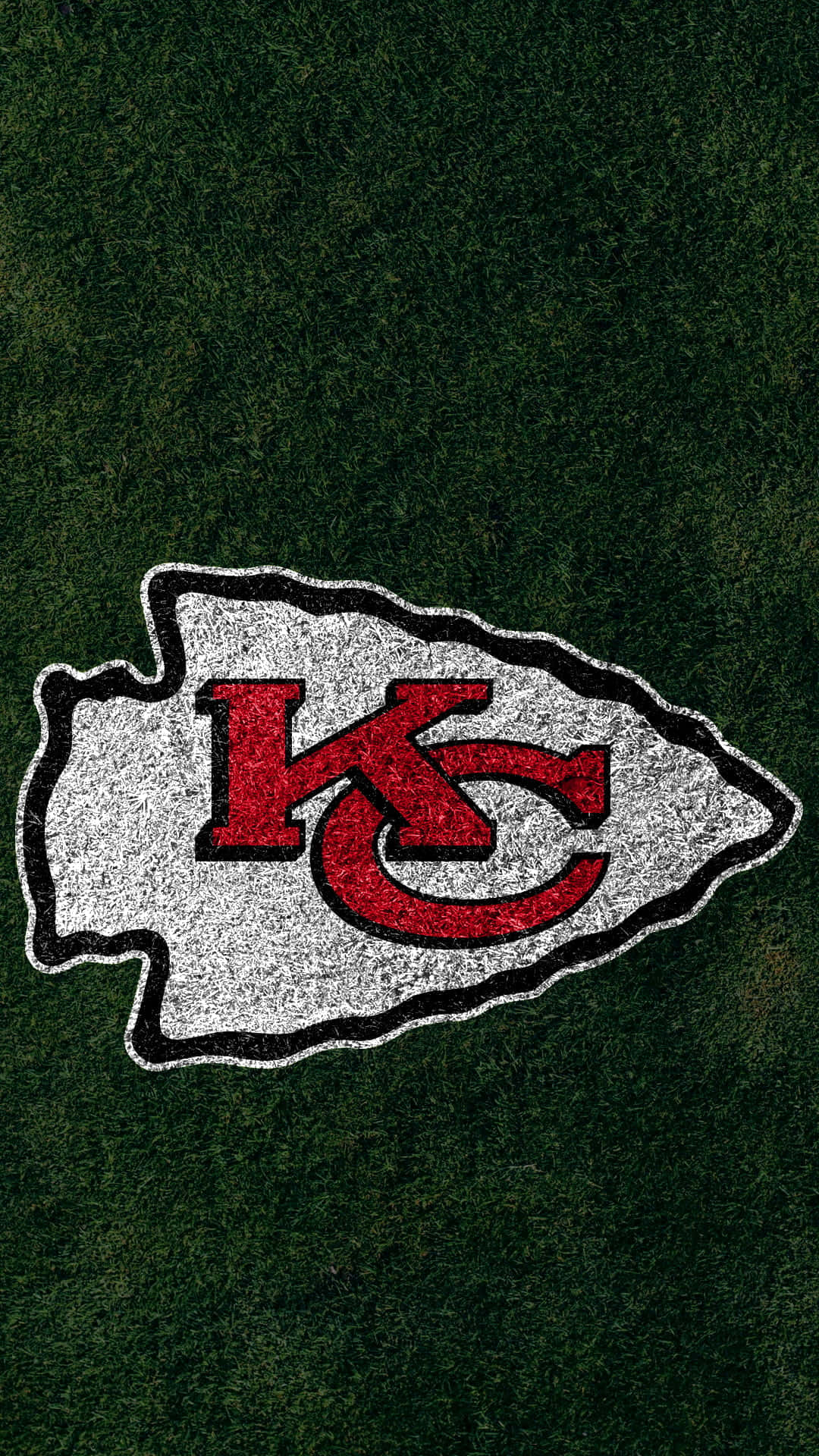Kansas Chiefs Logo On The Grass Background