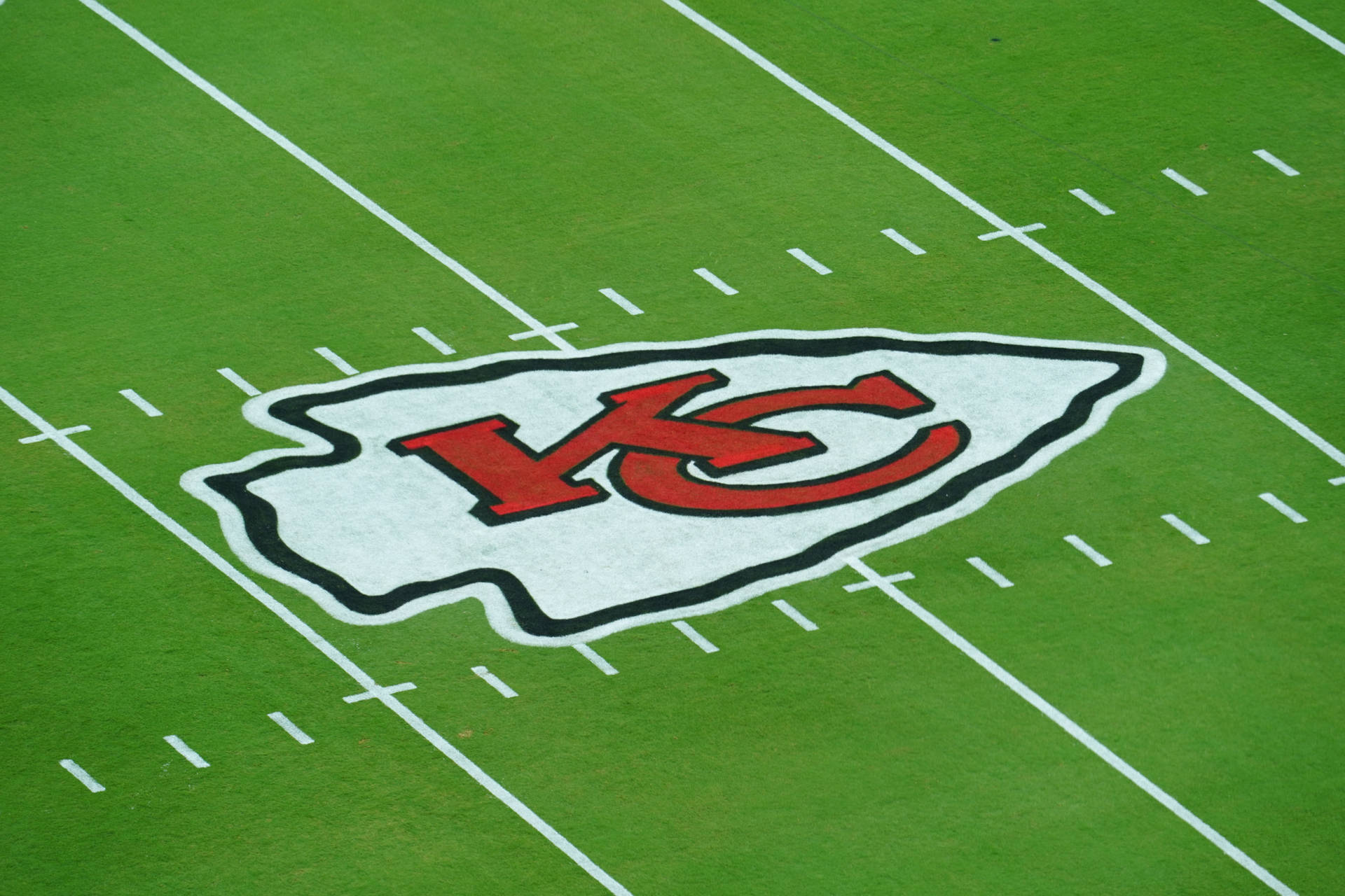 Kansas City Chiefs Logo On Field Background