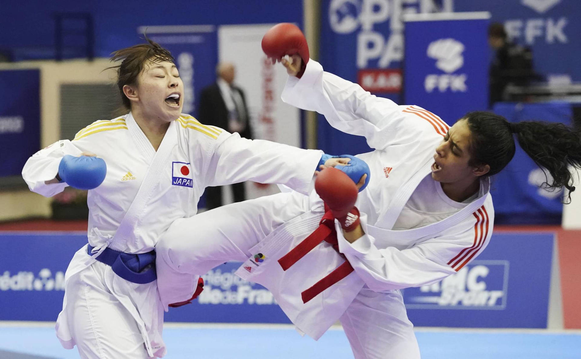 Karate Two Women Fighting Blue Belt Red Belt Background