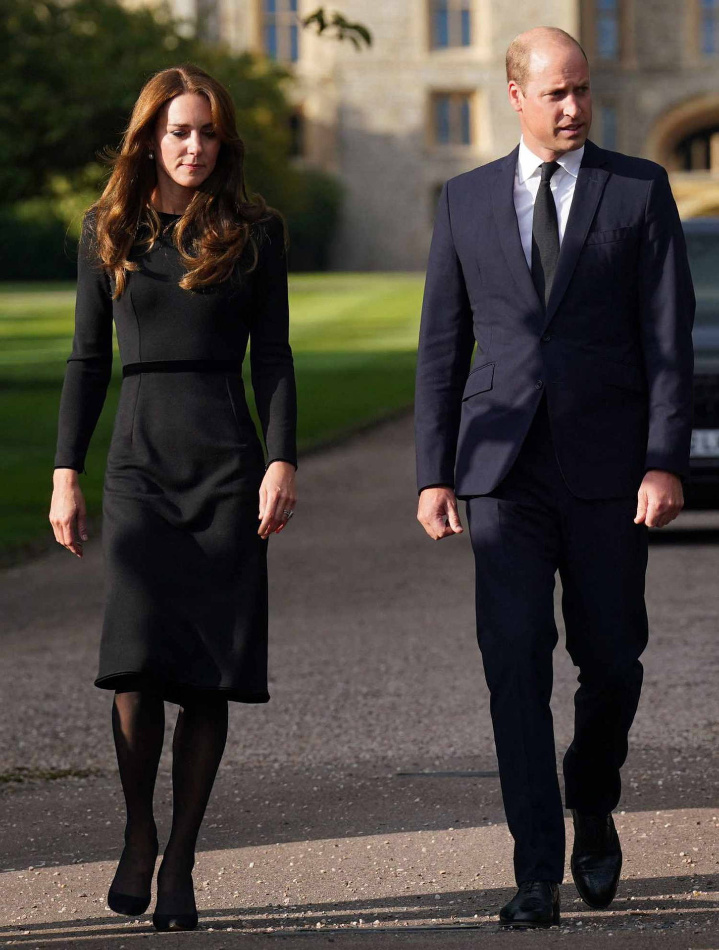 Kate And William Walk Past A Car In Front Of A Castle Background