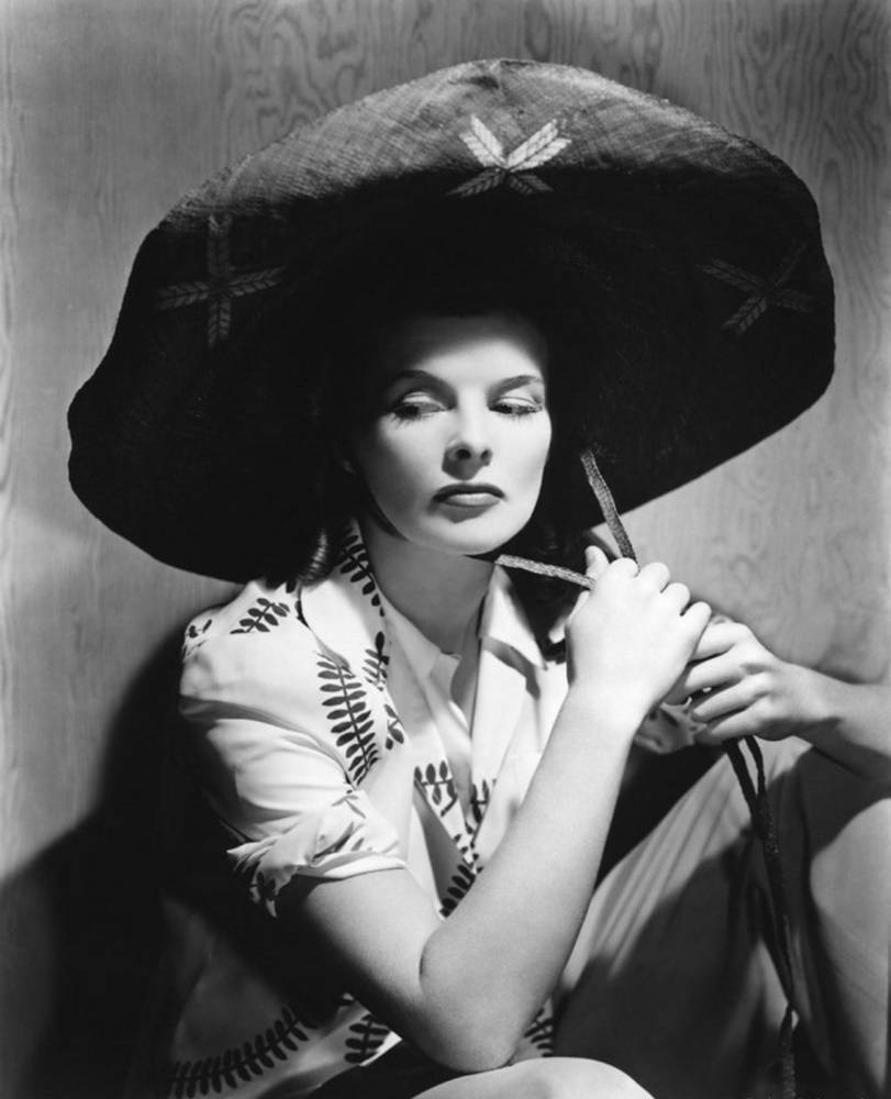 Katharine Hepburn Donning A Huge Hat Background