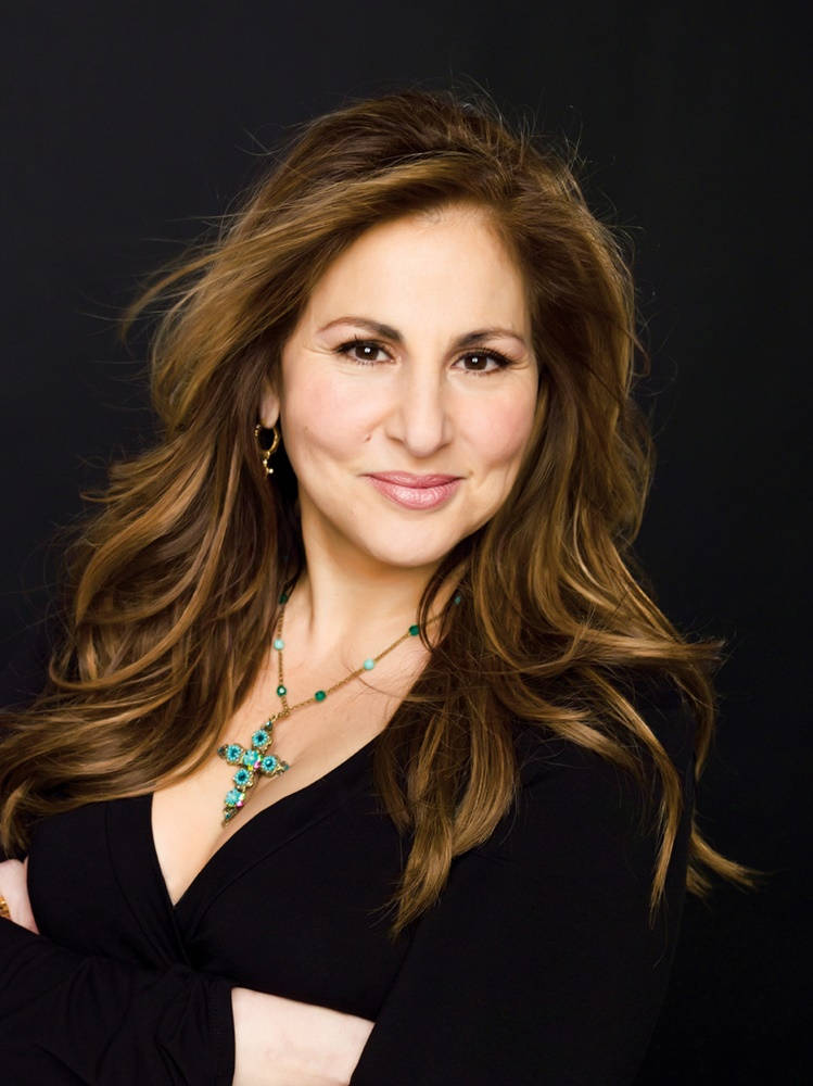 Kathy Najimy Posing Elegantly In Classy Black Outfit Background