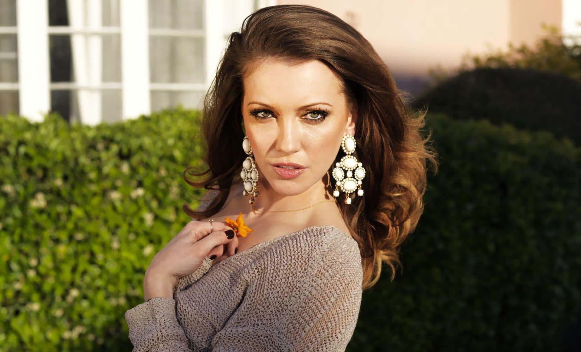 Katie Cassidy Striking A Captivating Pose Background