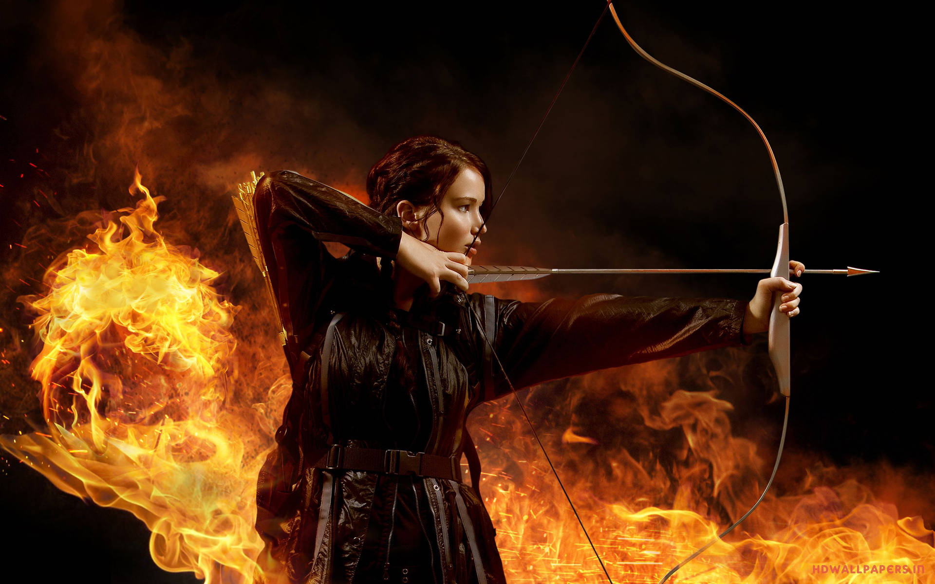 Katniss Everdeen From The Hunger Games Series Aiming With Bow Background