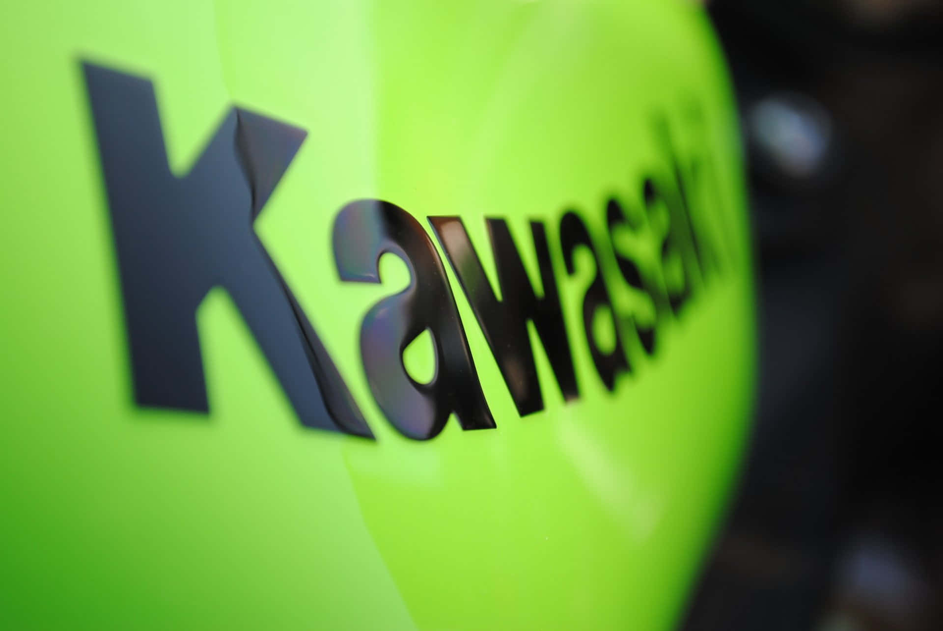 Kawasaki Logo On A Green Motorcycle Background