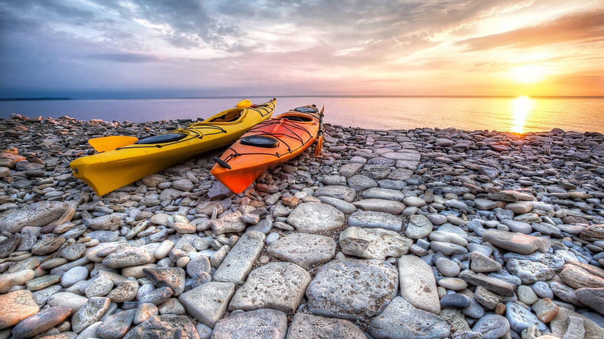 Kayaking Along The Rocky Shoreline Background