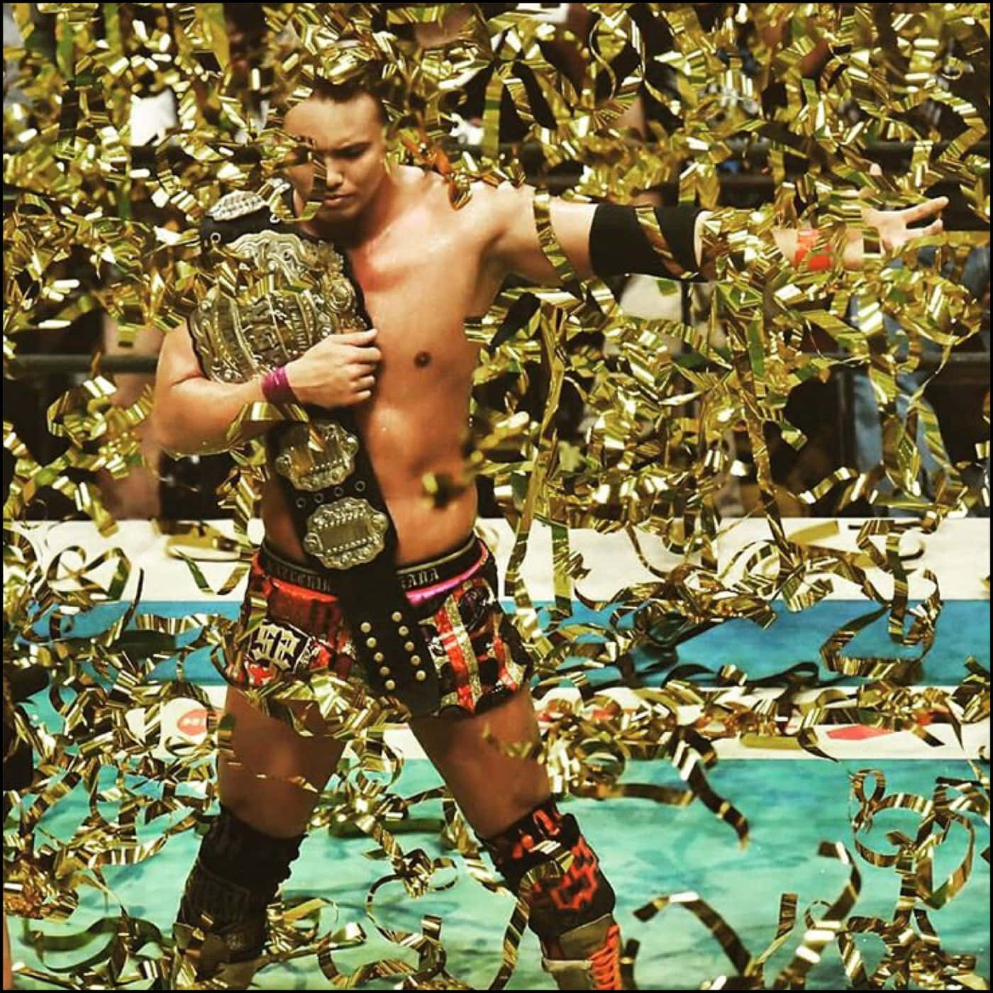 Kazuchika Okada Displaying His Championship Belt After A Victorious Match In New Japan Pro Wrestling.