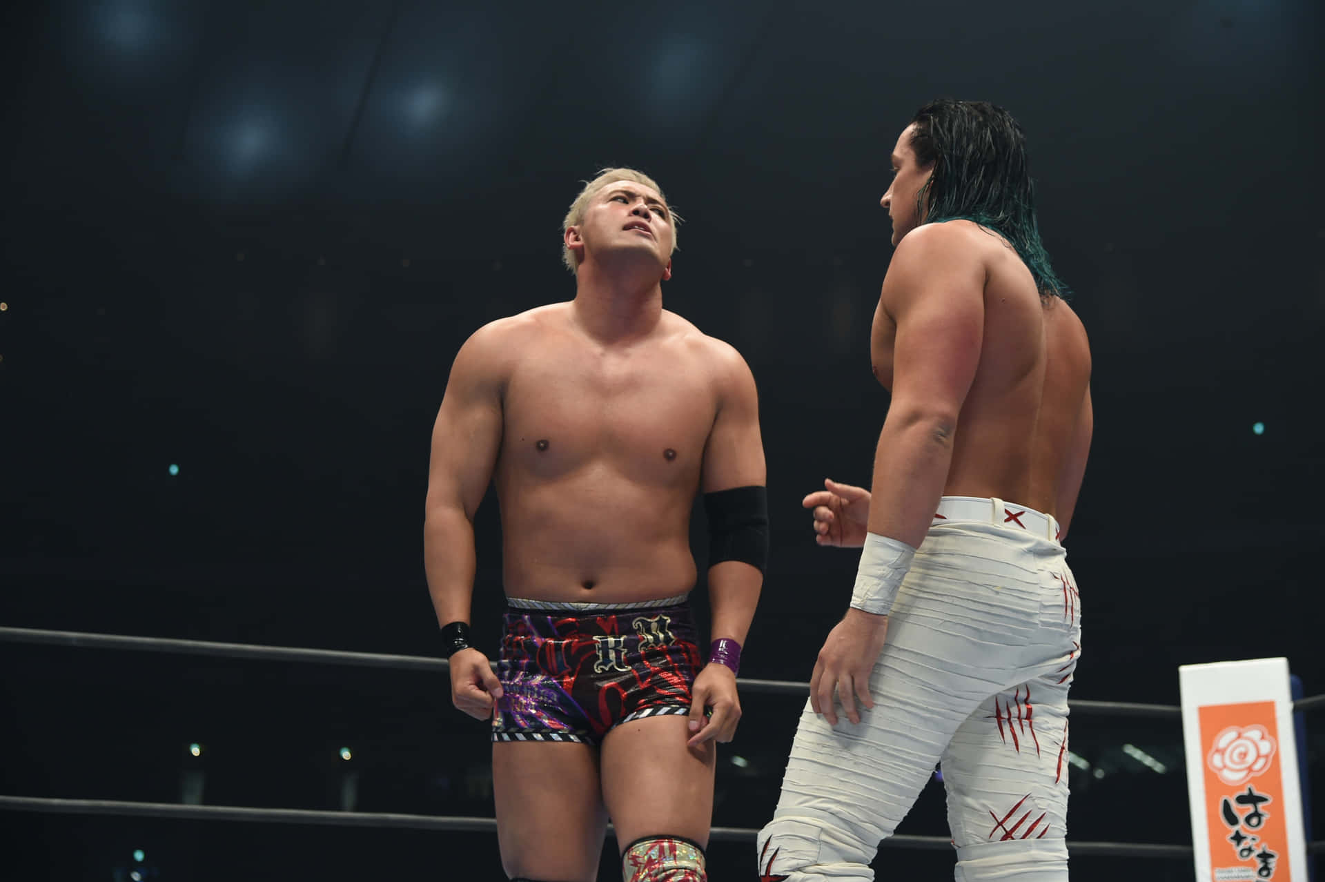 Kazuchika Okada Facing Off Jay White In An Intense Wrestling Match Background