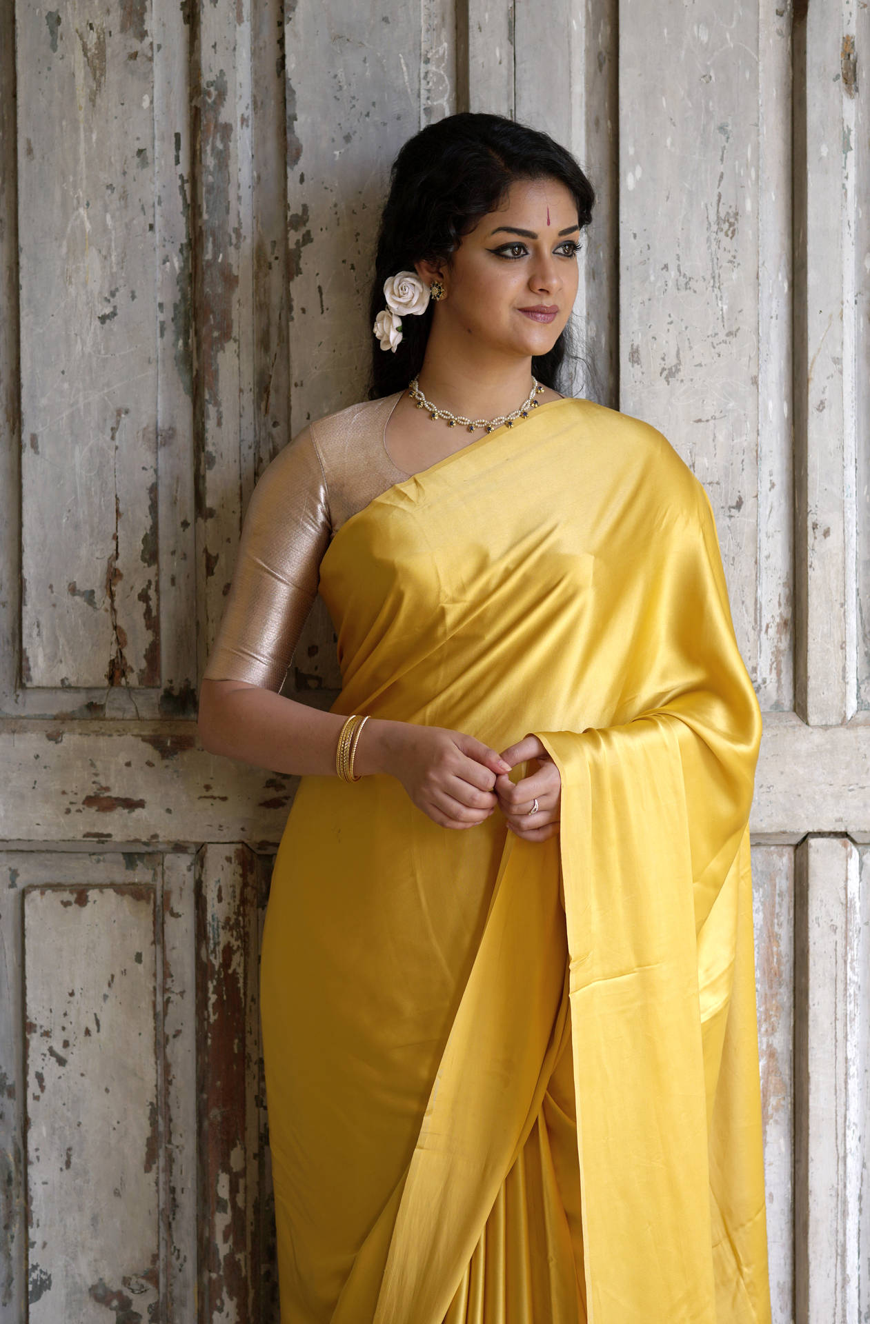 Keerthi Suresh Enchanting In A Golden Yellow Saree Background