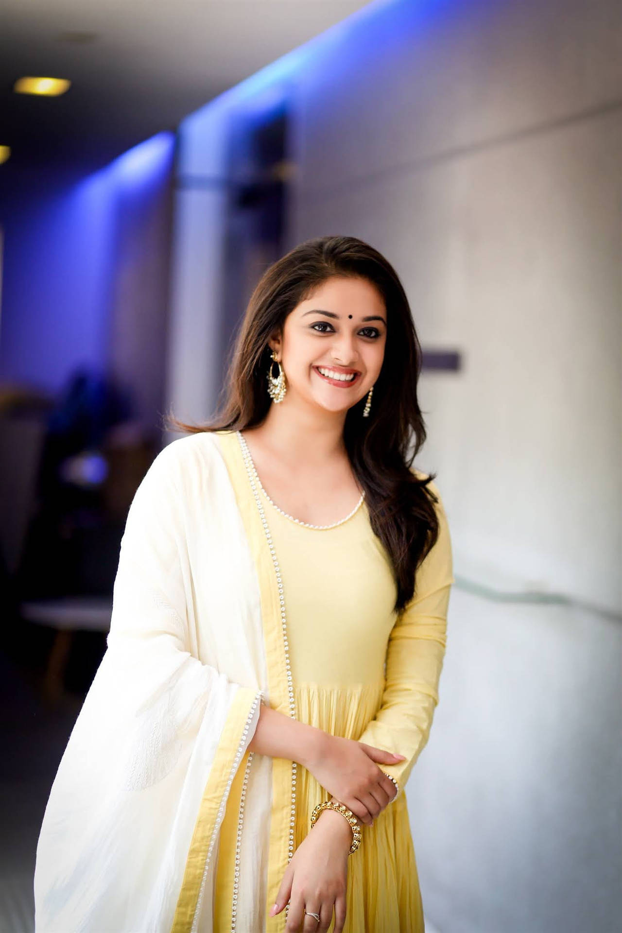Keerthi Suresh In A Yellow Dress Background