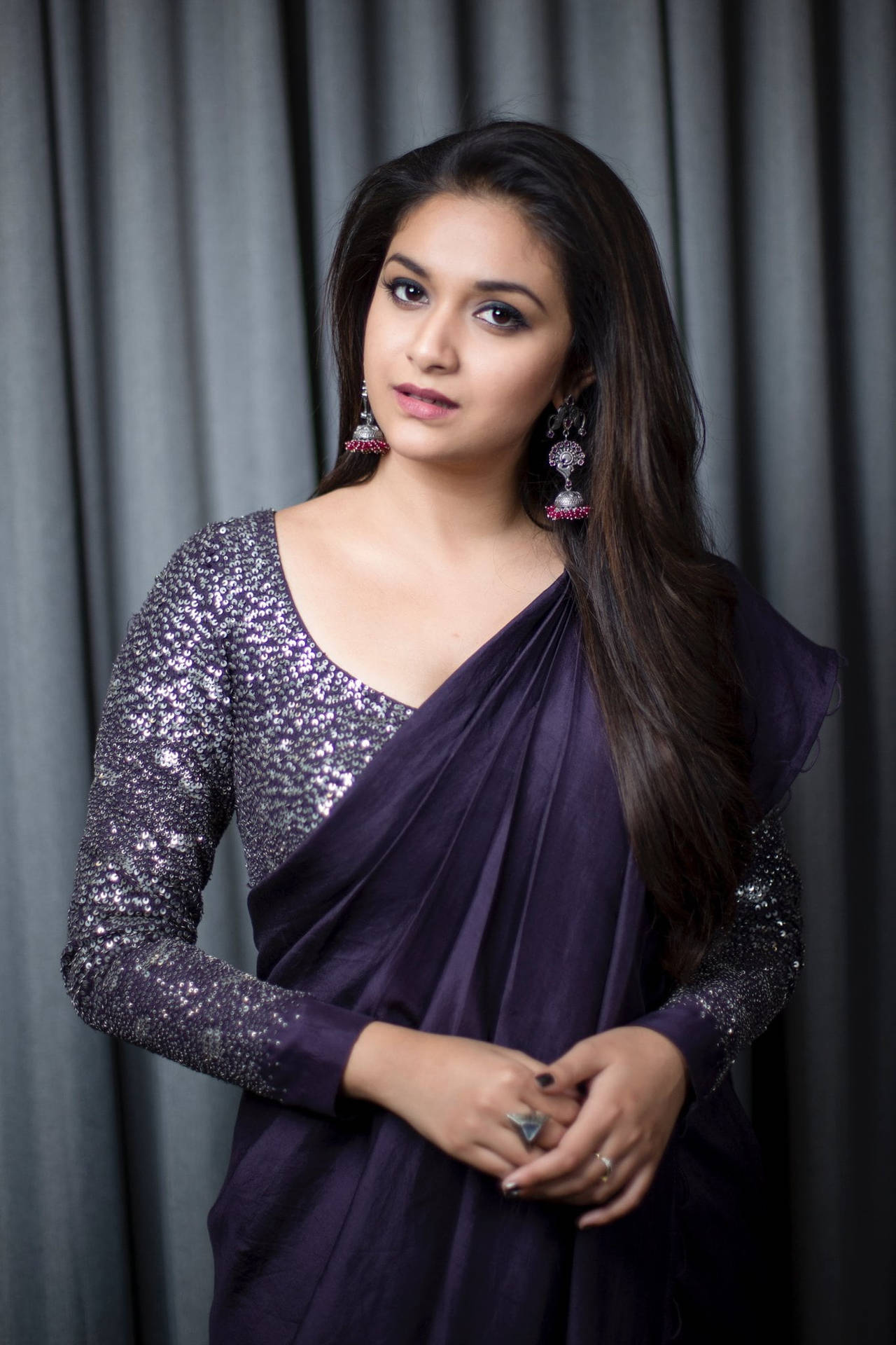 Keerthi Suresh Radiating Elegance In Dark Violet Outfit Background