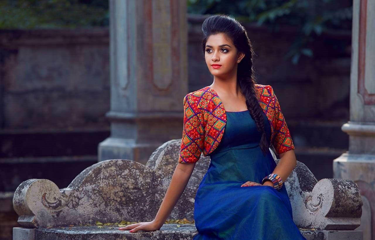 Keerthi Suresh Relaxing On A Stone Bench In High Definition Background
