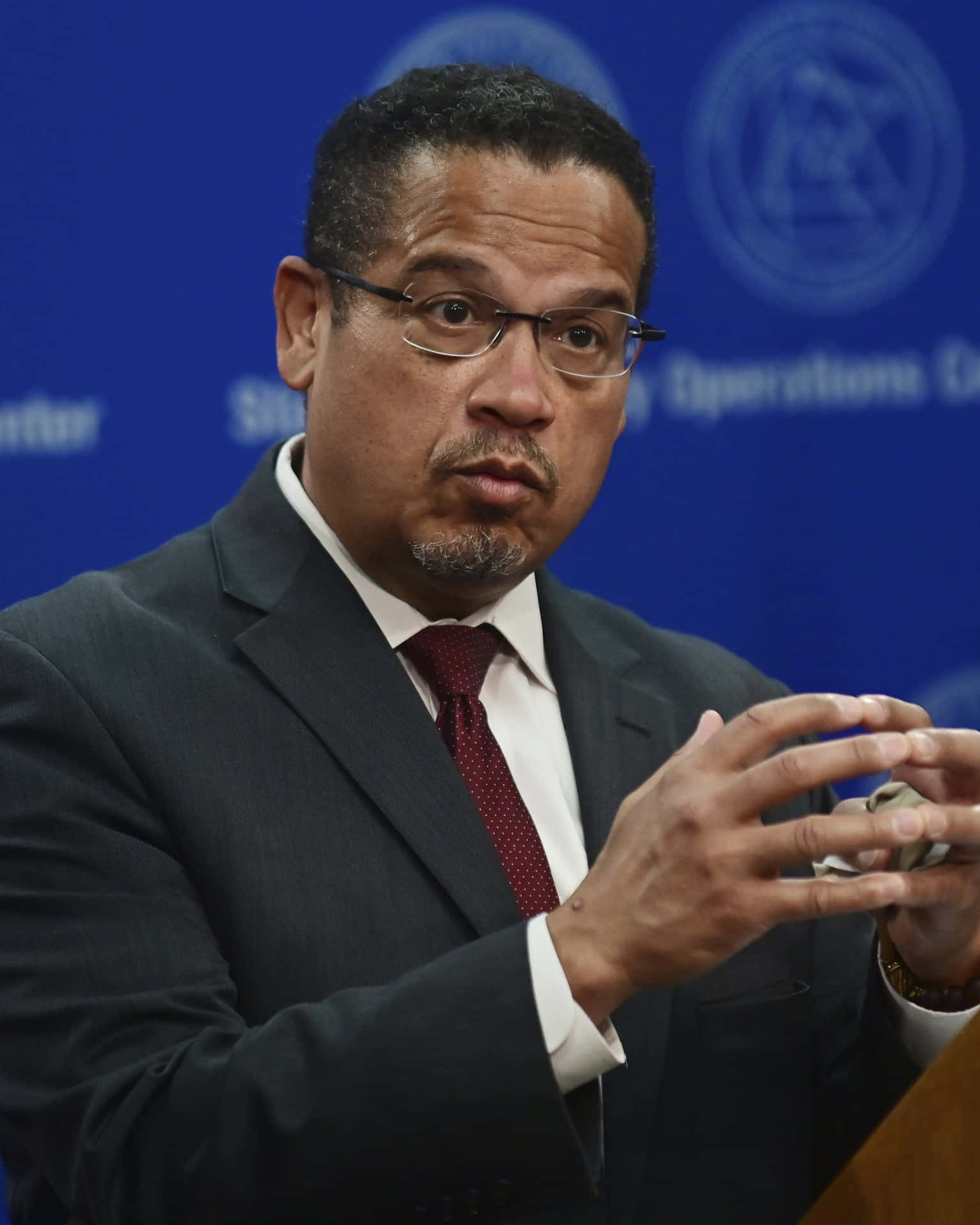 Keith Ellison Forming Hands Into Circle Background