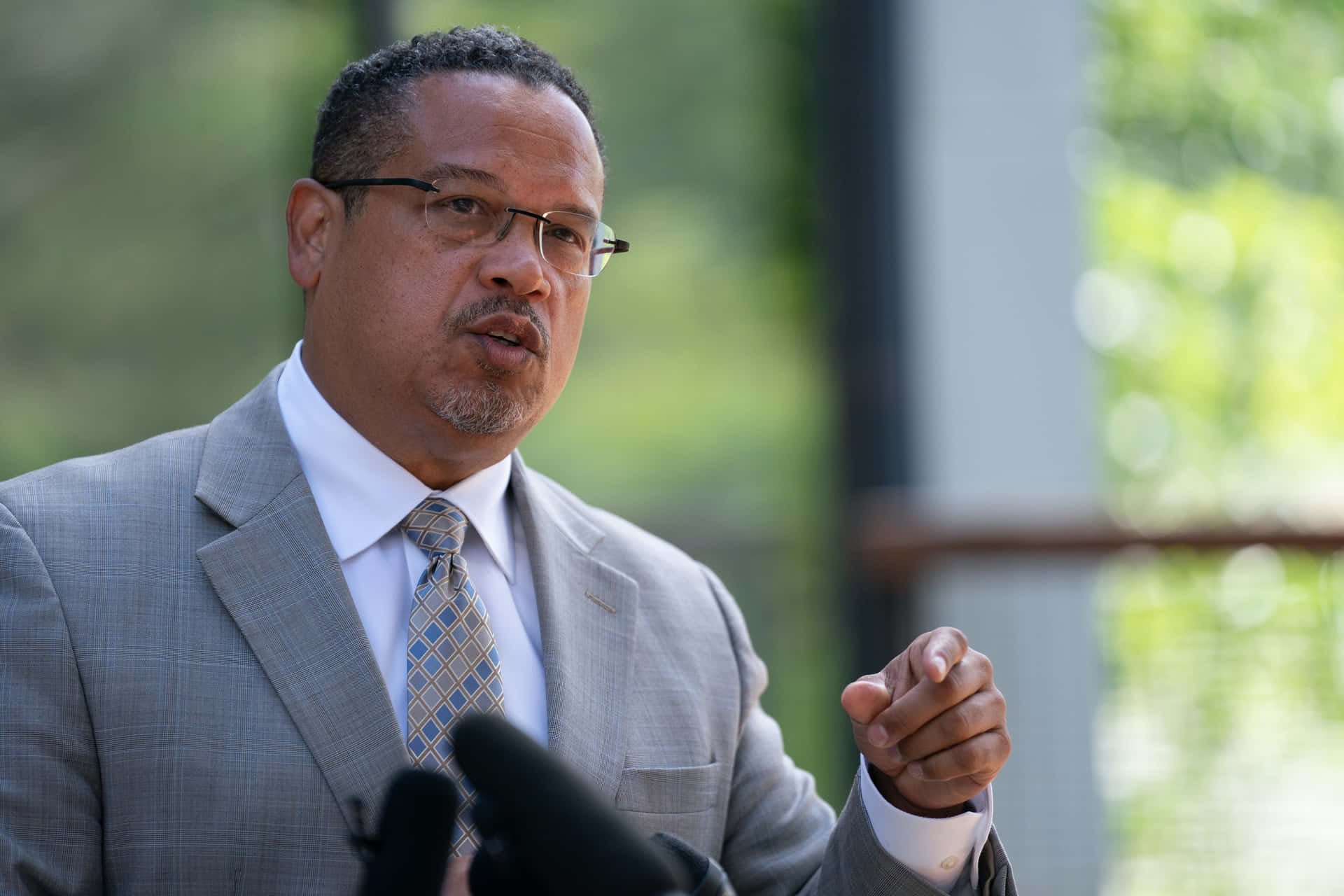 Keith Ellison Subtly Pointing Outwards Background