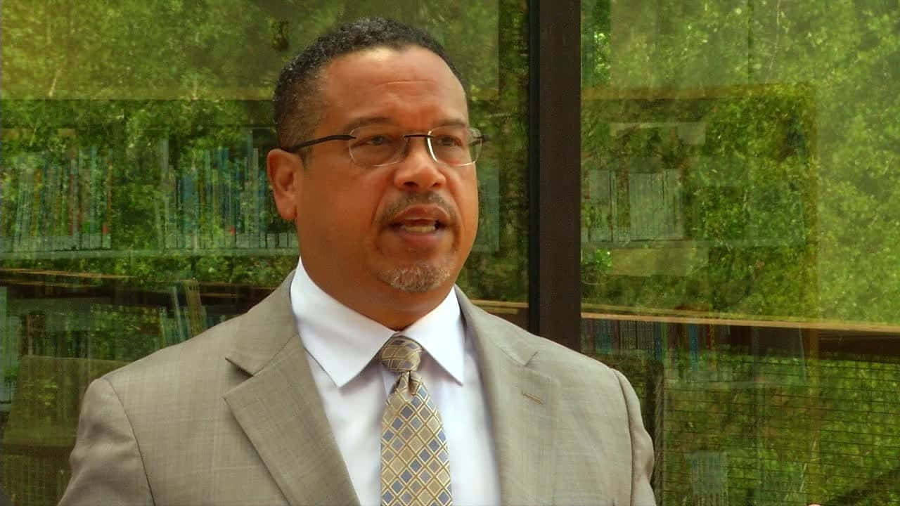 Keith Ellison With Green Glass Windows Background