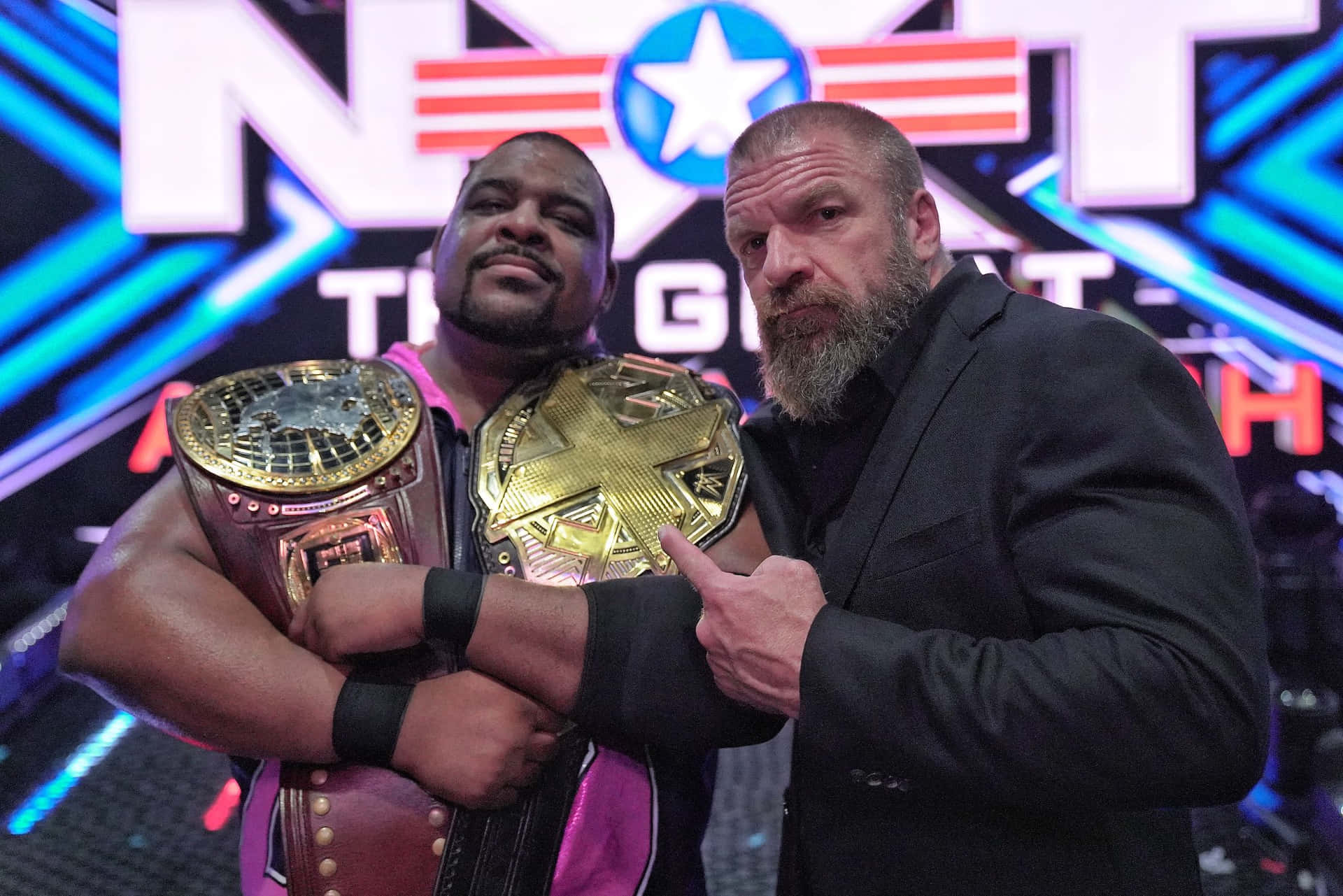 Keith Lee And Triple H Nxt Champion Belts Background