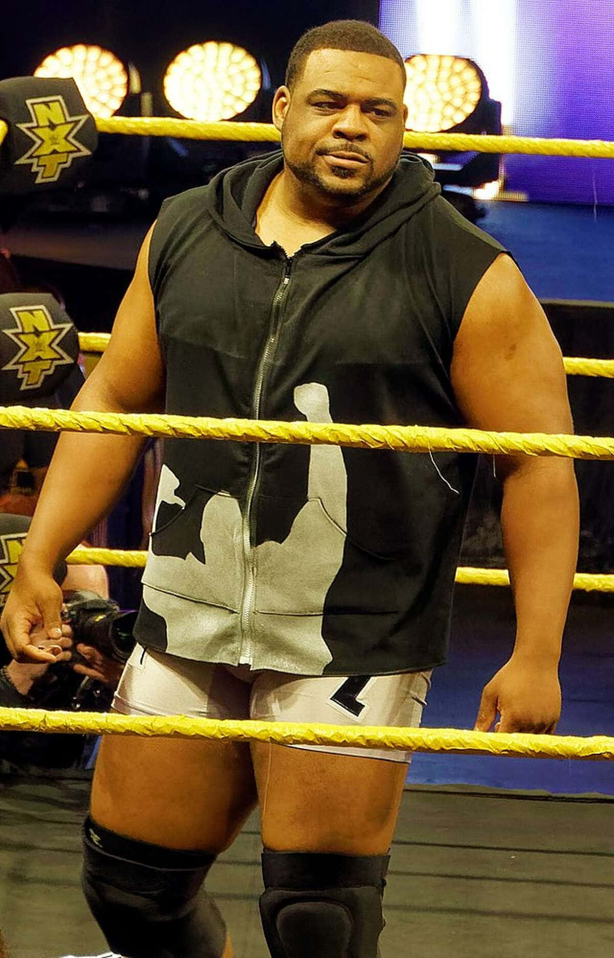 Keith Lee Holding His Championship Belt At A San Antonio Wrestling Event Background