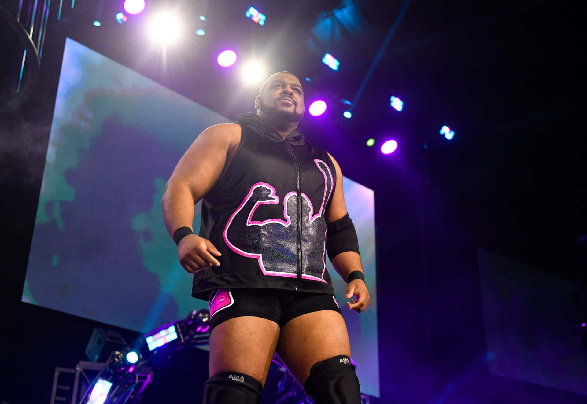 Keith Lee Striking A Pose In Aew Entrance Stage Background