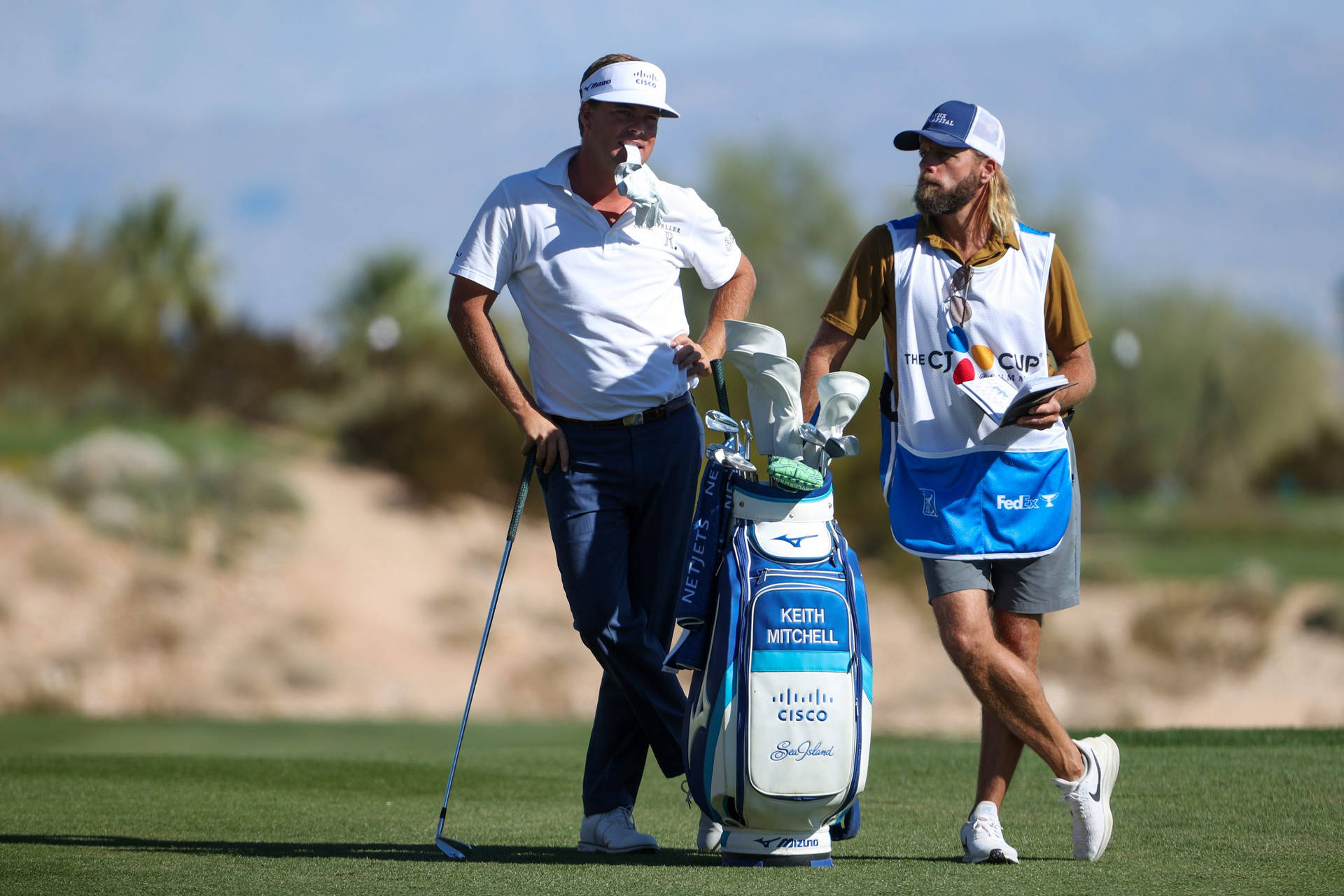 Keith Mitchell Enjoying A Moment With His Caddie Background