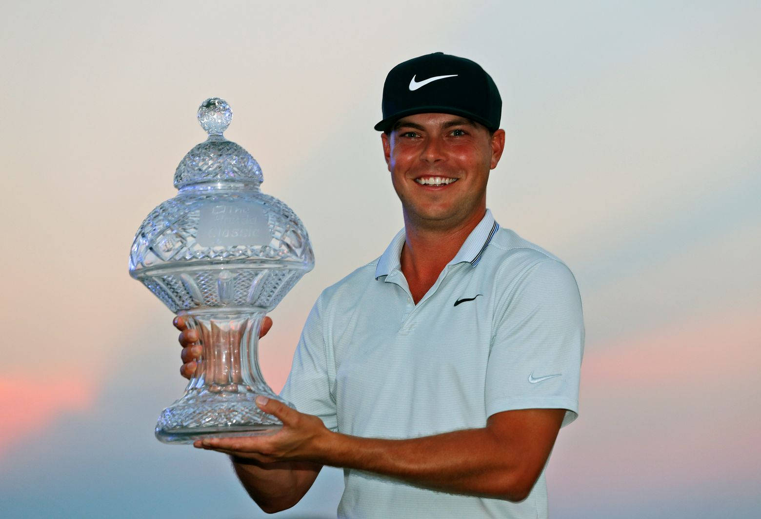 Keith Mitchell Holding A Trophy Background