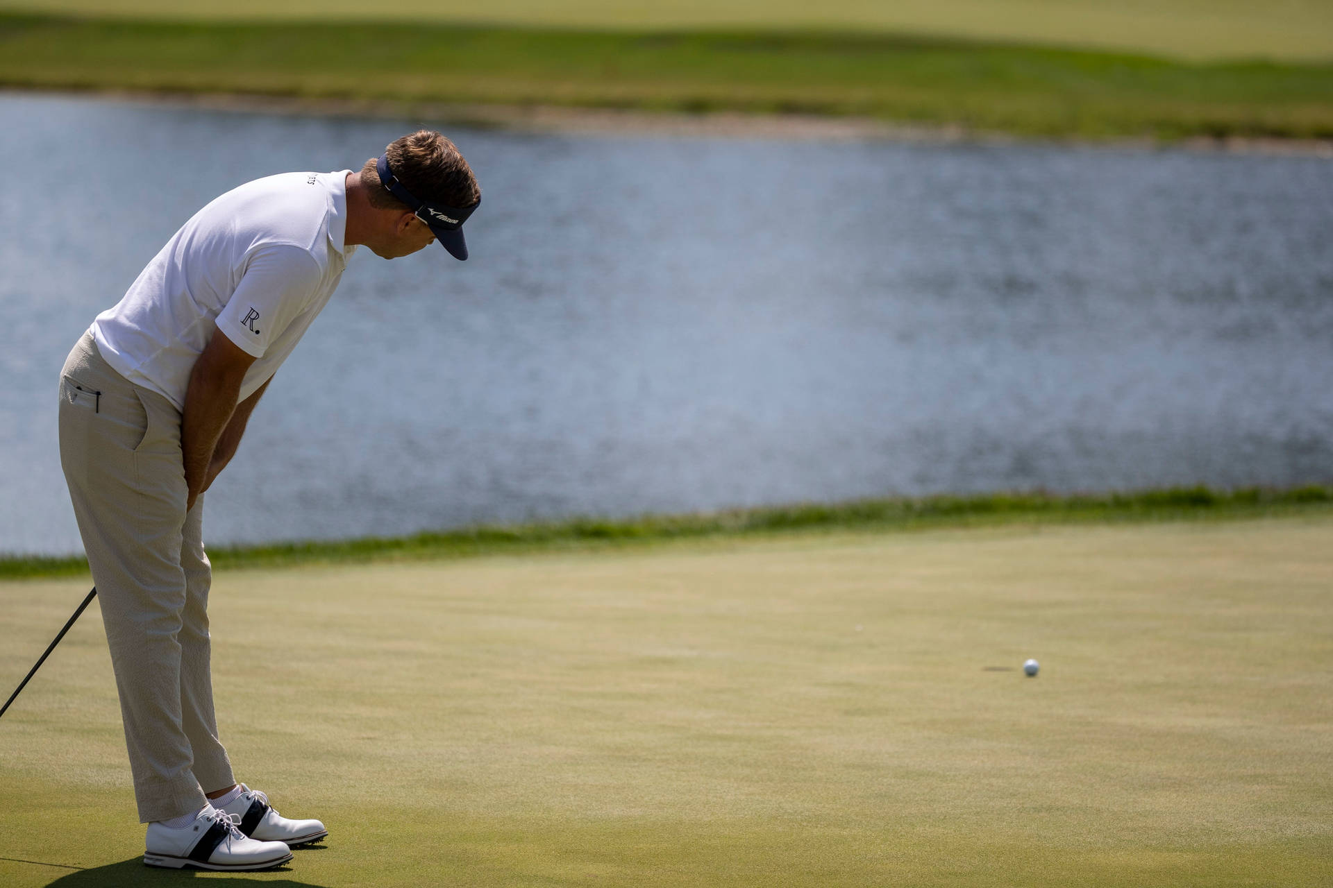 Keith Mitchell Staring At A Golf Ball Background