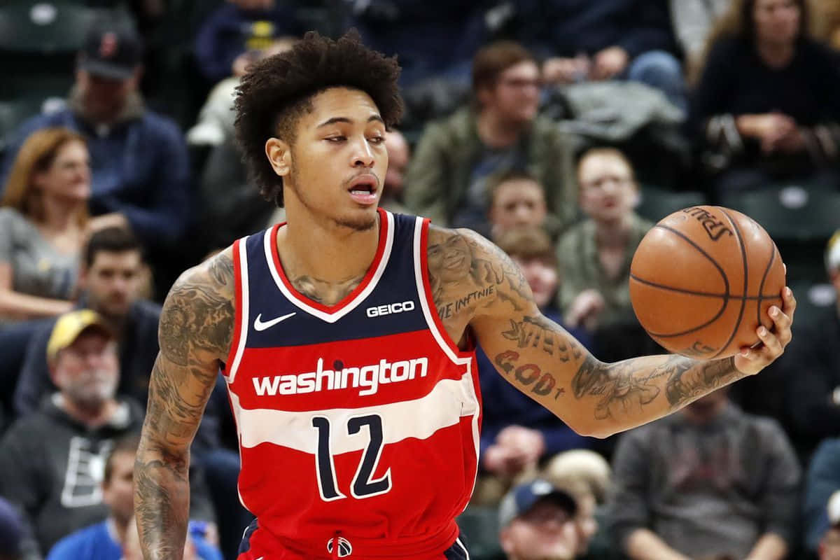 Kelly Oubre Jr. Looking At The Ball Background